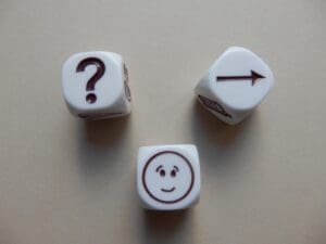dice with question mark, arrow, happy face