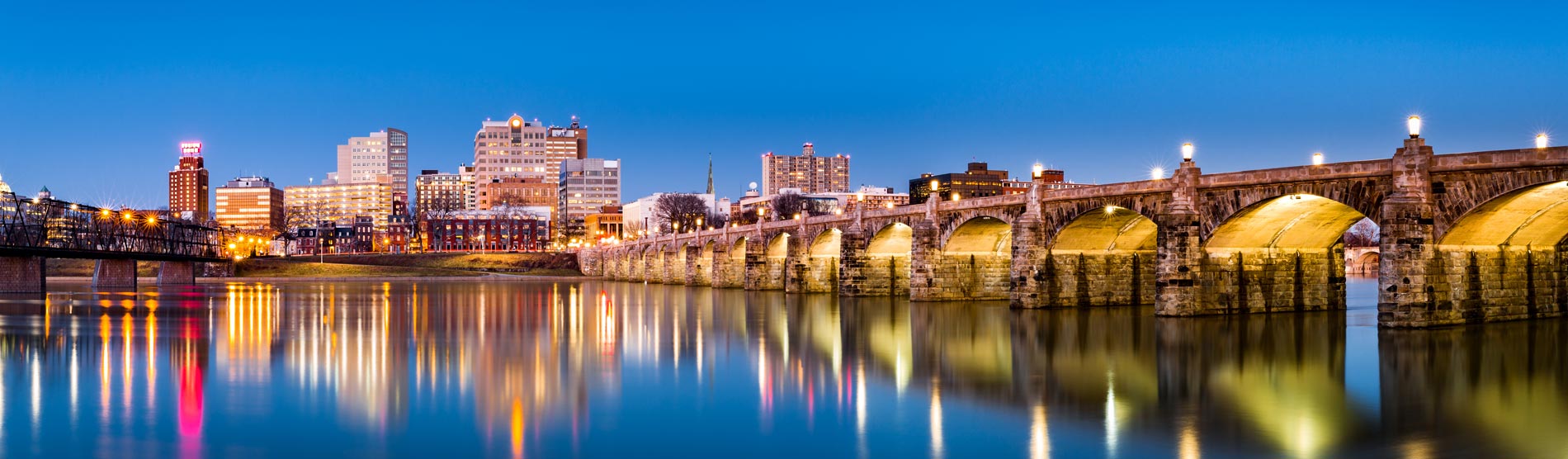 Harrisburg, Pennsylvania skyline with the historic Market Street Bridge reflected on the Susquehanna River at dusk